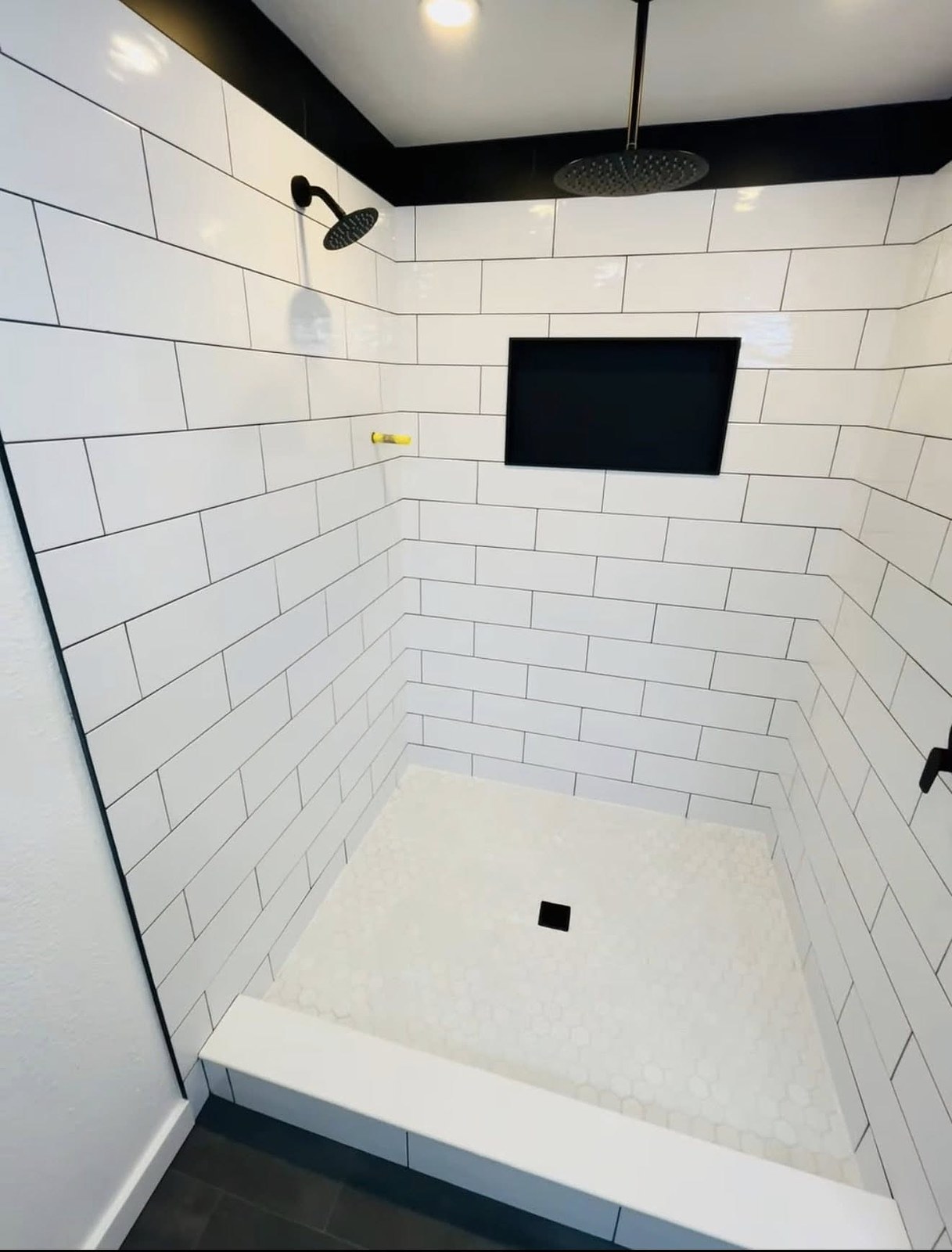 Modern white subway tile walk-in shower remodel with black accents in Wichita Kansas
